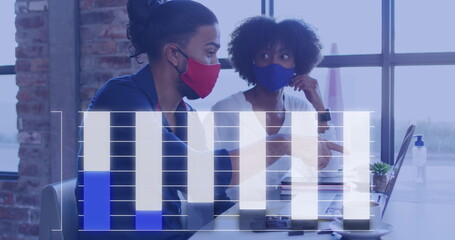 Image of graph over diverse male and female colleagues in face masks