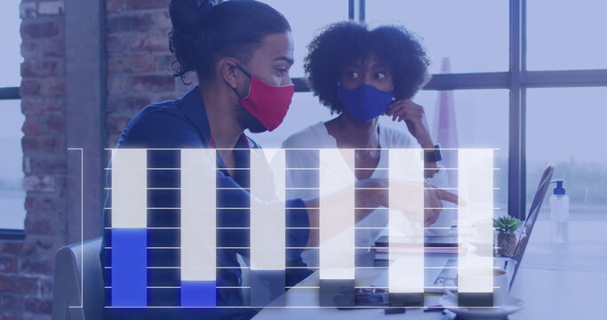 Image of graph over diverse male and female colleagues in face masks