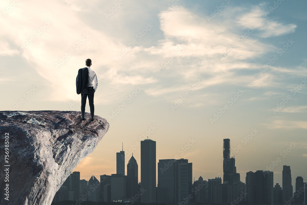 Poster back view of businessman standing on cliff edge on bright blue sky with mock up place background. fu