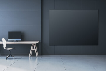 Modern minimalistic black interior with workplace and computer monitor, mock up banner on wall. 3D Rendering.