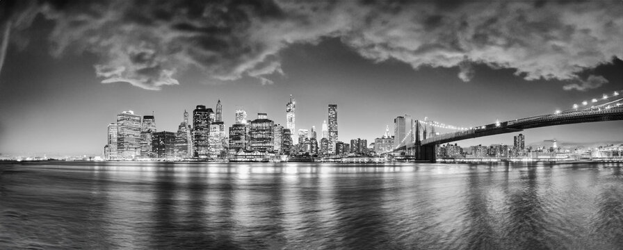 New York City night lights. Lower Manhattan and Brooklyn Bridge panorama from Brooklyn Bridge Park