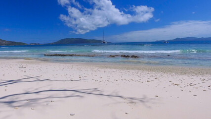 Grand Sister Island close to La Digue, Seychelles. Aerial view of tropical coastline on a sunny day - 756989387