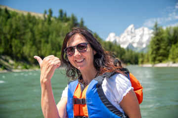 A beautiful woman on a boat excursion to Grand Teton National Park - 756990109