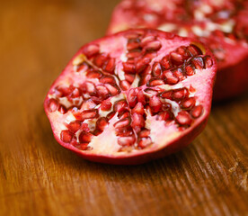 Wellness, fruit and pomegranate on wooden table in kitchen for diet, health or nutrition closeup. Food, minerals and vitamins with healthy produce on counter or surface in apartment for detox
