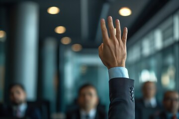 Close-up of a raised hand in a business conference, concept of volunteering, participation, and corporate engagement.