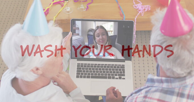 Senior couple video chatting with a teenage girl on a laptop