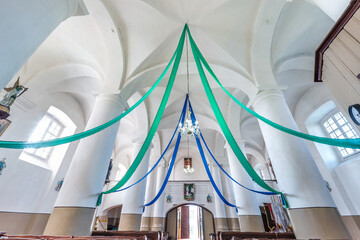 interior dome and looking up into a old gothic catholic  church ceiling decorated with colored...