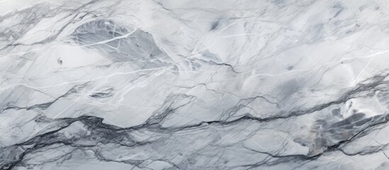 A closeup of a snowcovered white marble texture on a freezing winter landscape, showcasing the glacial landform and bedrock beneath the icy surface