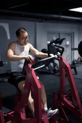 Fototapeta na wymiar Men exercise their arm muscles in the gym
