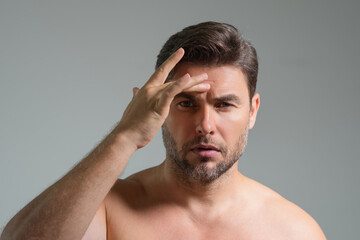 Obraz premium Mens skincare. Attractive man with perfect skin touch face after shaving. Skin care healthcare cosmetic procedures concept. Close up man with sensitive skin, male cosmetology treatment. Skin care.