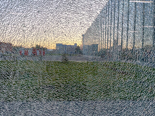 Broken window. The reflection of the city in the broken glass of a building. 
 - obrazy, fototapety, plakaty