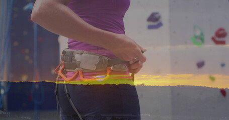 Image of data processing over caucasian woman climbing wall