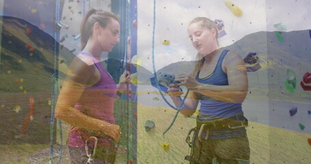 Image of landscape over caucasian women by climbing wall