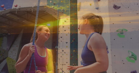 Image of landscape over caucasian women by climbing wall