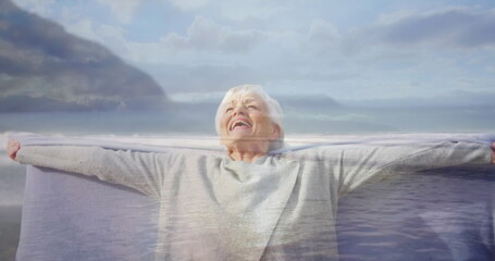 Fototapeta premium Close up of an old Caucasian woman happily stretching her arms wide