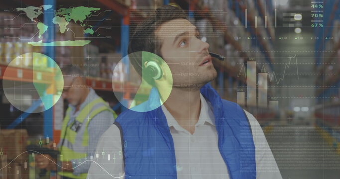 Male worker with headset checks inventory as data moves in foreground.