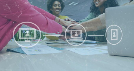 Image of icons and data processing over diverse business people stacking hands in office