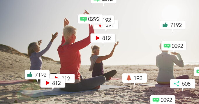 Image of social media notifications, over women doing yoga on beach - Powered by Adobe