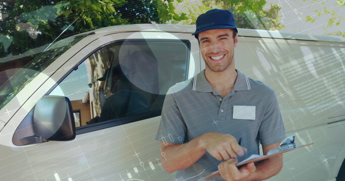 Front view of a deliveryman beside a van writing on a clipboard smiles and signals a thumbs up