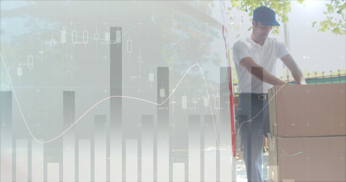 Low angle of a male Caucasian worker unloading packages on a trolley from the back of a delivery van