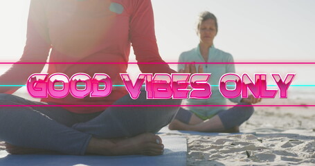 Image of text good vibes only, in shiny pink, with happy senior women meditating on beach