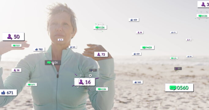 Image of social media notifications, over happy woman doing yoga on beach - Powered by Adobe