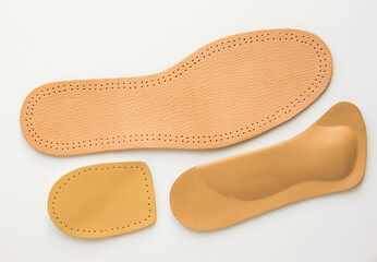 Leather insoles of different textures on white background. Foot care products.