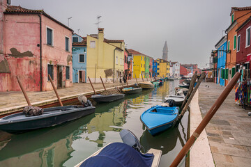 Fototapeta na wymiar Burano colored houses during Winter time with fog background
