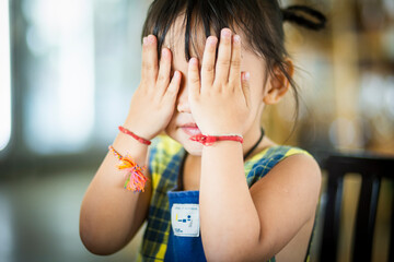 The girl sat at the table waiting for the food to be served. hungry children at a party Celebration in the restaurant People eat breakfast and lunch.