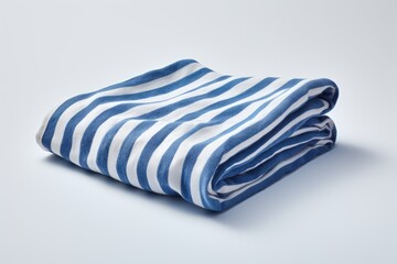 A folded beach towel with blue stripes is placed alone on a white background representing a decoration idea for a summer vacation resort