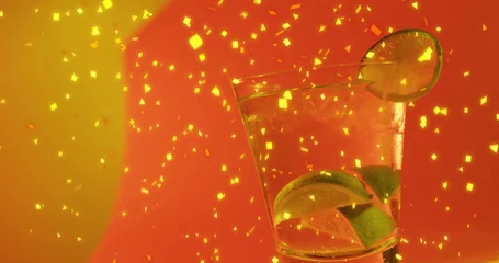  Image of confetti falling and cocktail on red background © vectorfusionart