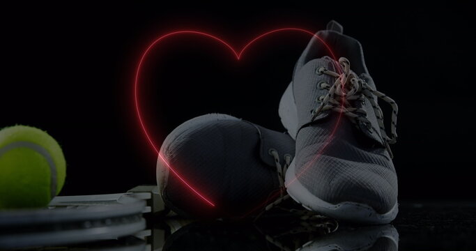 Fototapeta Image of neon hearts over ball and sport shoes