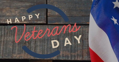 Image of happy veterans day text over american flag and wooden background