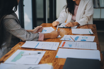 Business team working with new startup project plan and discussion information for financial strategy with laptop and digital tablet in a modern business lounge.