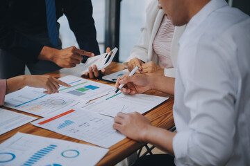 Business team working with new startup project plan and discussion information for financial strategy with laptop and digital tablet in a modern business lounge.