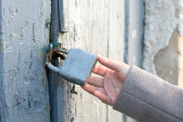 Female hand holding closed padlock