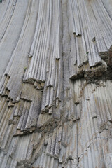 Obraz premium texture of porous stones on the beach, nature, natural phenomena, grey stones, columnar stones, lava rocks 