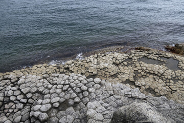 texture of porous stones on the beach, nature, natural phenomena, grey stones, columnar stones,...