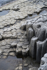 texture of porous stones on the beach, nature, natural phenomena, grey stones, columnar stones,...