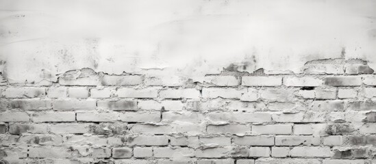 A monochrome photograph showcasing a brick wall in an urban landscape. The contrast between the building and the sky creates an artistic look