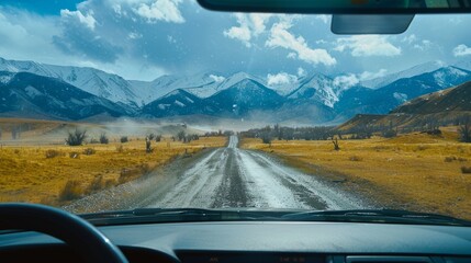 An aerial view of the landscape through the windshield of a car going across a meadow to high rocky mountains in different seasons with varying weather. The “natural landscape” is viewed from inside - obrazy, fototapety, plakaty