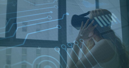 Image of processor elements and screens with data processing over woman wearing vr headset