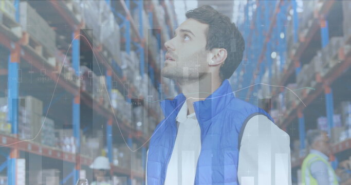 Image of statistics and financial data processing over man working in warehouse