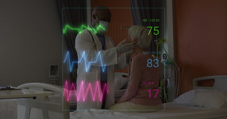 Image of vital signs readings over diverse male doctor examining senior female patient