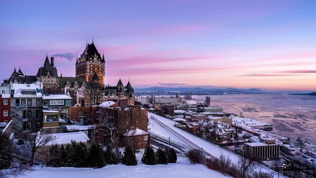 Night to day time lapse of pinky alpenglow over Fairmont Le Ch&acirc;teau Frontenac in winter morning at Quebec City