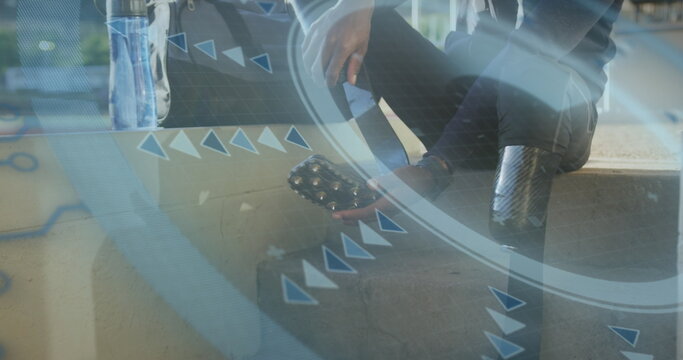 Image of digital data processing over disabled male athlete taking off running blades