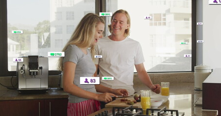 Image of social media notifications over smiling couple preparing breakfast in sunny kitchen