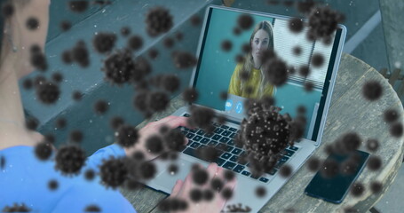 Image of covid 19 cells over businesswoman on laptop image call