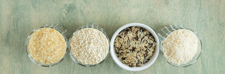 banner of different types of rice. wild rice, sushi rice, shredded and steamed rice on a green wooden background. healthy food concept. Soft focus. top view