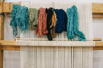 Colorful skeins of silk thread to create traditional Turkish carpet on a loom.
